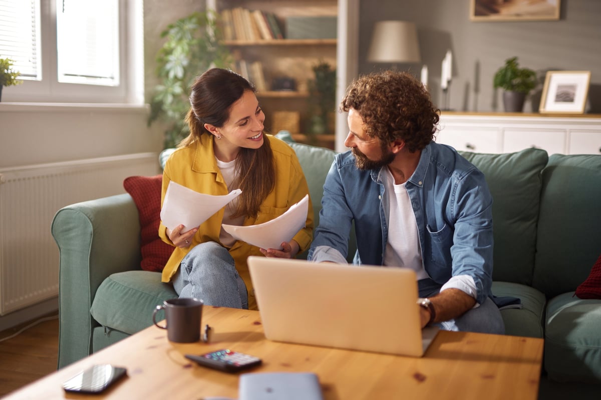 Family managing their finances together with laptop