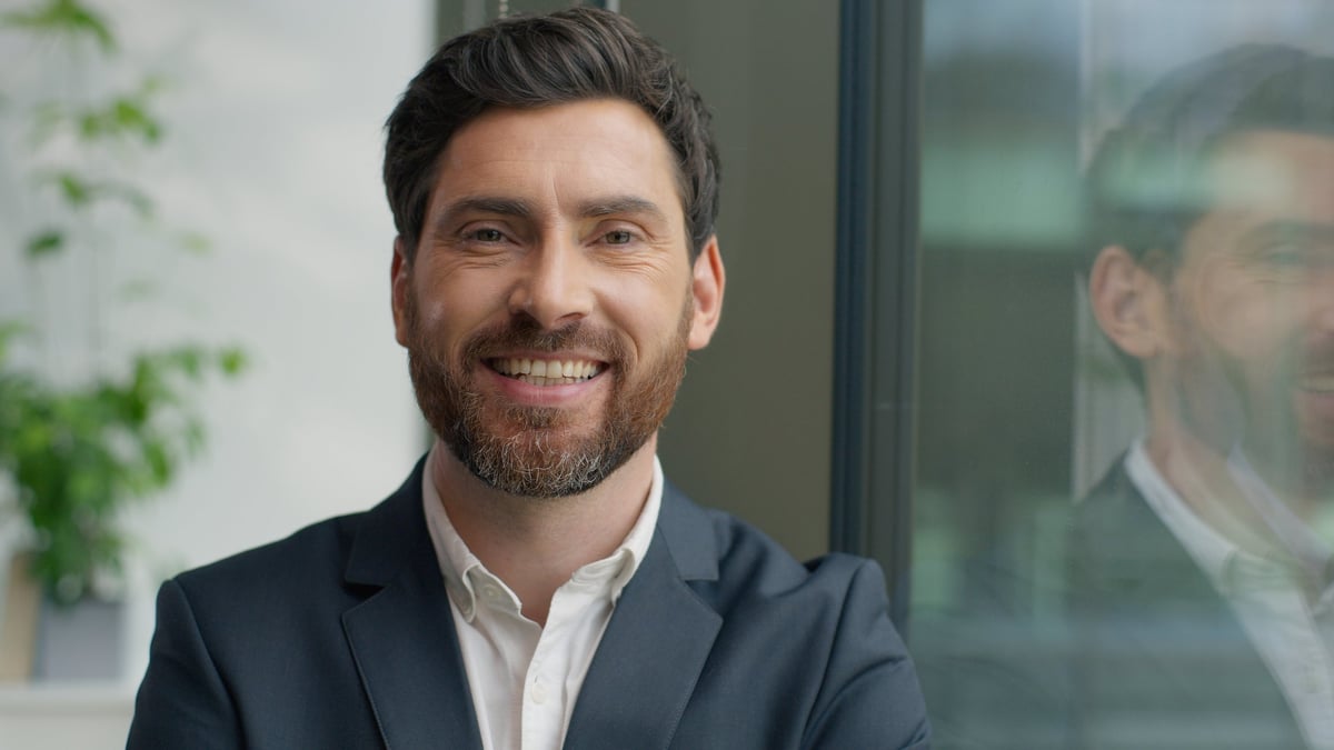 Portrait happy smiling confident Caucasian middle-aged business man